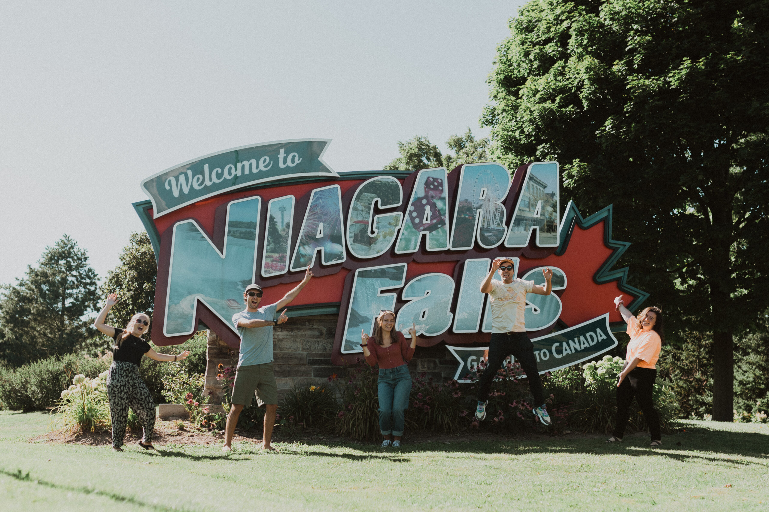 YWAM Niagara Mission Adventures, youth at Niagara Falls sign